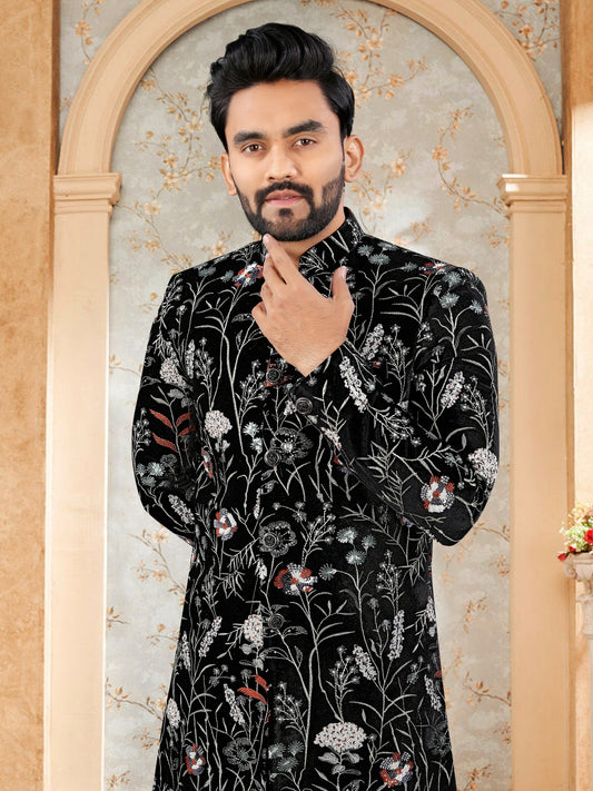 Man wearing a black floral patterned shirt in an ornate frame