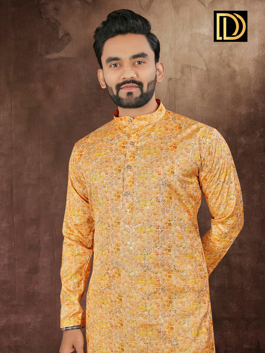 Man wearing a yellow patterned kurta against a brown background