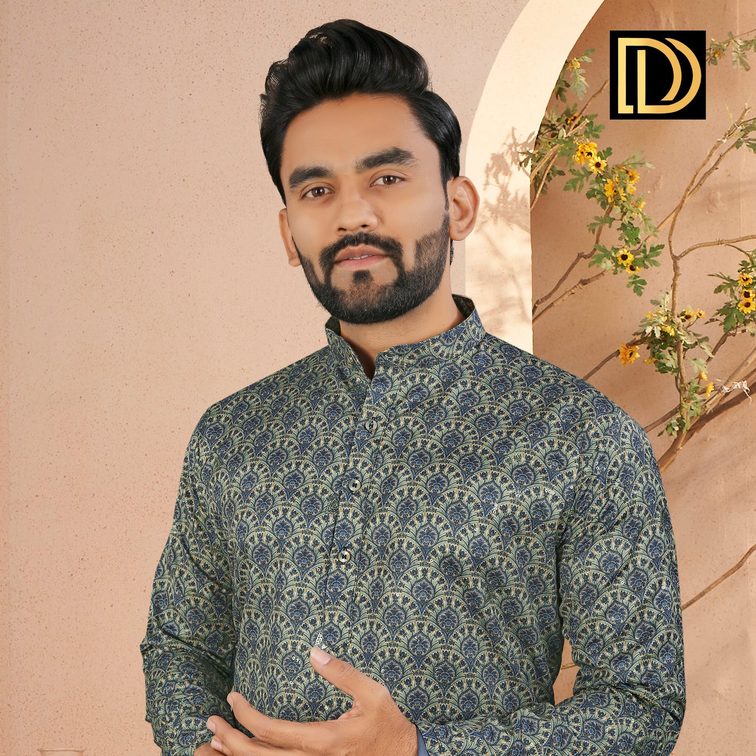 Man wearing a patterned kurta with a decorative background