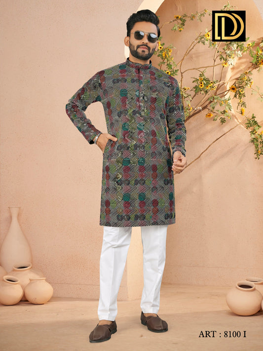 Man wearing a patterned kurta with white pants against a beige background