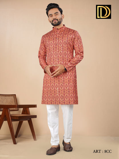 Man wearing a red kurta with white pants against a beige background