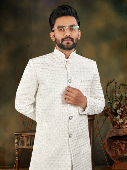 Man wearing a white traditional outfit with a blurred background