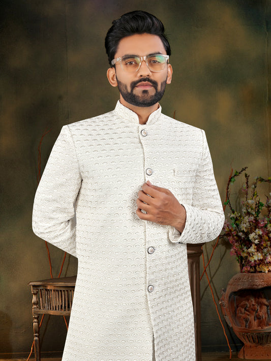 Man wearing a white traditional outfit with a blurred background