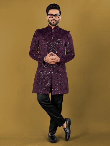 Man wearing a purple sherwani with black pants on a brown background