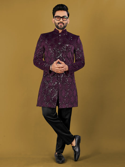 Man wearing a purple sherwani with black pants on a brown background
