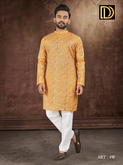 Man wearing a yellow kurta with white pants against a brown background