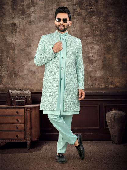 Man wearing a light green sherwani with a textured background