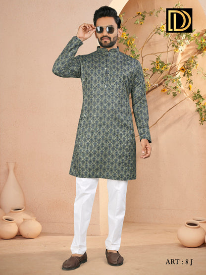 Man wearing a green kurta with white pants in a decorated indoor setting