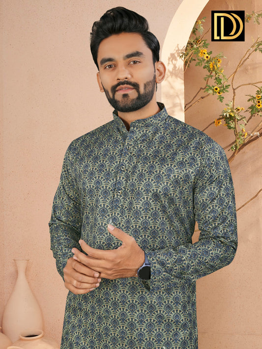 Man wearing a patterned kurta against a beige wall with decorative elements.