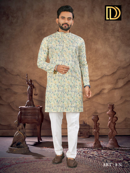 Man wearing a floral kurta with white pants in a decorative setting