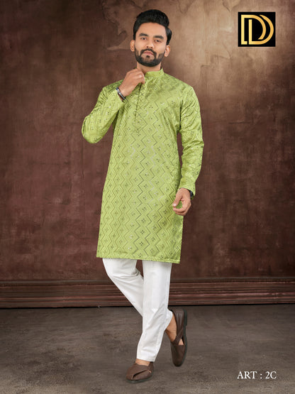 Man wearing a green kurta with white pants against a brown background