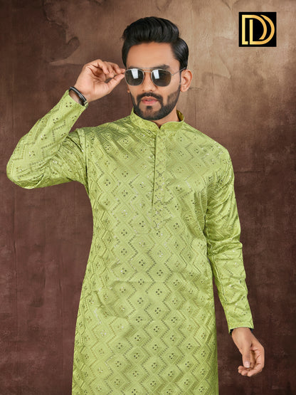 Man wearing a green embroidered kurta against a brown background