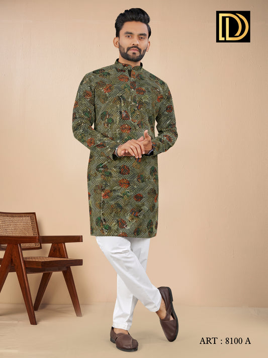 Man wearing a patterned kurta with white pants against a beige background