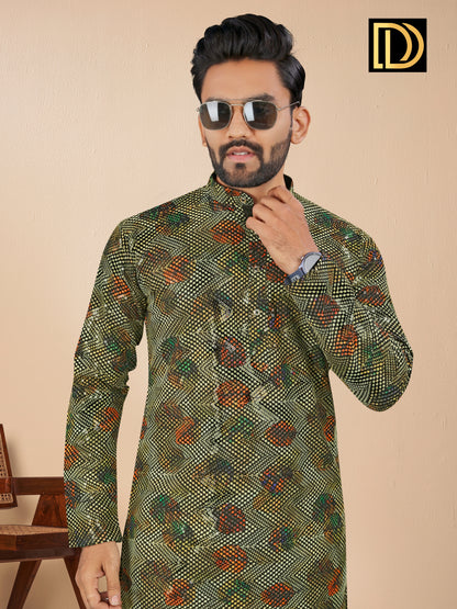 Man wearing a patterned green kurta with sunglasses and a watch, against a beige background.